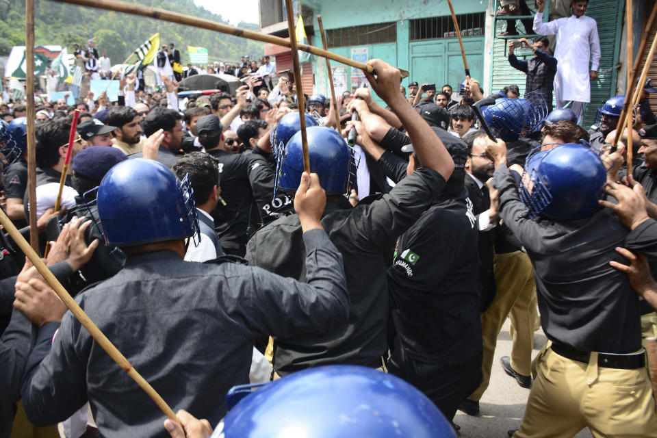 Pakistani police officers use force to stop protesters from reaching the Line of Control between Pakistan and Indian Kashmir, at the border town of Chakoti, in Pakistani Kashmir, Thursday, Aug. 29, 2019. Kashmir is divided between India and Pakistan since they won independence from British colonialists in 1947. They have fought two wars over its control. (AP Photo/M.D. Mughal)