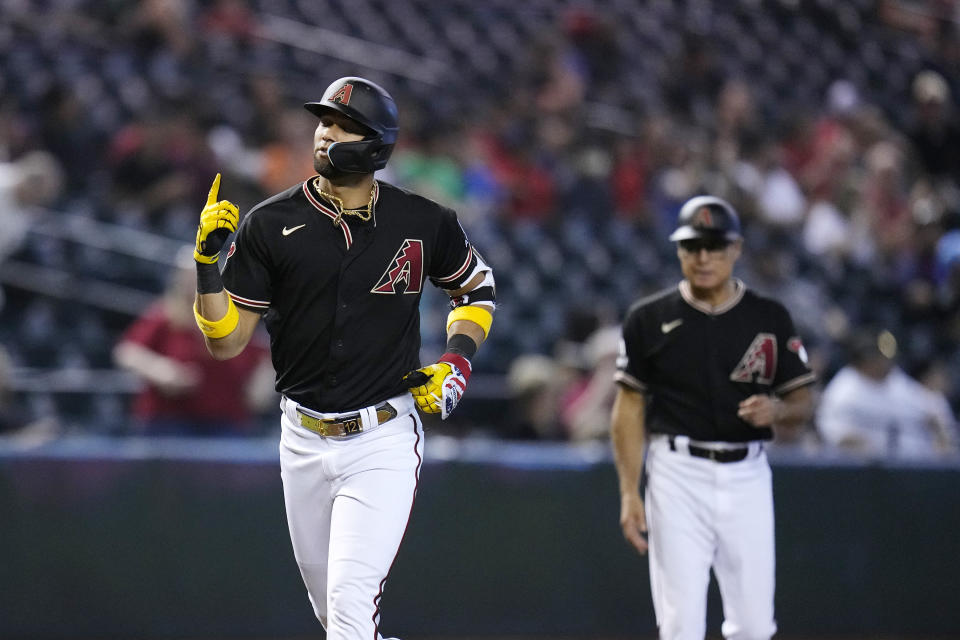 Arizona Diamondbacks' Lourdes Gurriel Jr., left, rounds the bases after hitting a home run against the Colorado Rockies as Diamondbacks third base coach Tony Perezchica looks on during the eighth inning of a baseball game Wednesday, Sept. 6, 2023, in Phoenix. The Diamondbacks won 12-5. (AP Photo/Ross D. Franklin)