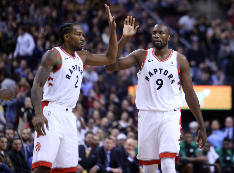 TORONTO, ON - OCTOBER 19:  Kawhi Leonard #2 and Serge Ibaka #9 of the Toronto Raptors react late in the second half of an NBA game against the Boston Celtics at Scotiabank Arena on October 19, 2018 in Toronto, Canada.  NOTE TO USER: User expressly acknowledges and agrees that, by downloading and or using this photograph, User is consenting to the terms and conditions of the Getty Images License Agreement.  (Photo by Vaughn Ridley/Getty Images)