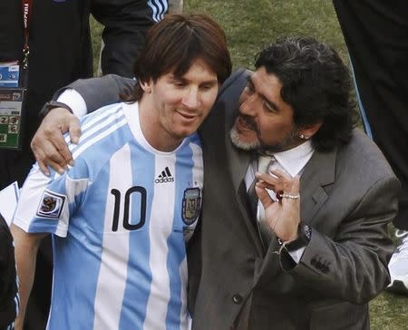 Argentina's coach Diego Maradona (R) hugs Lionel Messi after their 2010 World Cup Group B soccer match against South Korea at Soccer City stadium in Johannesburg June 17, 2010. REUTERS/Amr Abdallah Dalsh/Files