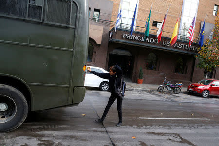 A demonstrator uses a spray on a riot police vehicle during an unauthorized march called by secondary students to protest against government education reforms in Santiago, Chile, May 26, 2016. REUTERS/Ivan Alvarado