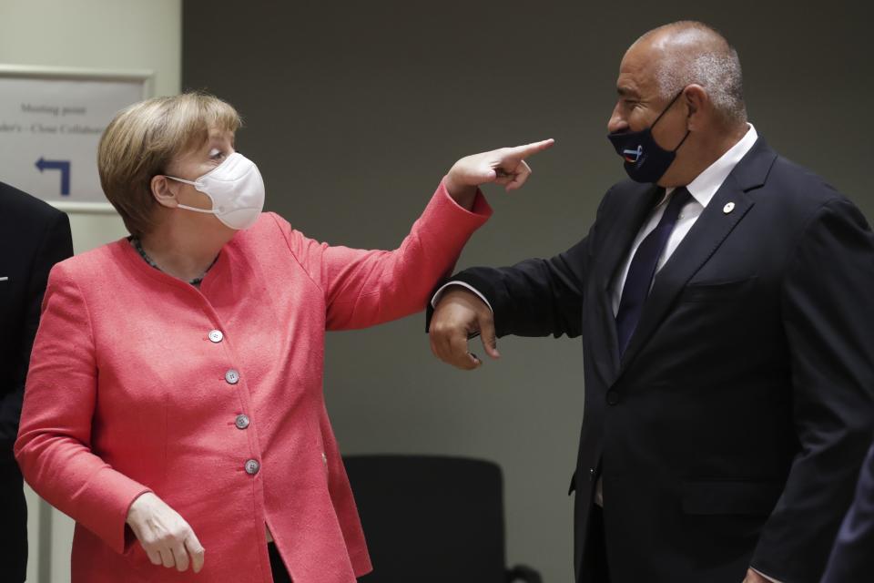 German Chancellor Angela Merkel, left, speaks with Bulgaria's Prime Minister Boyko Borissov during a round table meeting at an EU summit in Brussels, Friday, July 17, 2020. Leaders from 27 European Union nations meet face-to-face on Friday for the first time since February, despite the dangers of the coronavirus pandemic, to assess an overall budget and recovery package spread over seven years estimated at some 1.75 trillion to 1.85 trillion euros. (Stephanie Lecocq, Pool Photo via AP)