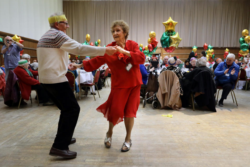 Anita Monk and her neighbour John Everett dance during a Christmas Dinner event for older people at Hammersmith and Fulham Town Hall in London, Britain December 25, 2016. REUTERS/Kevin Coombs