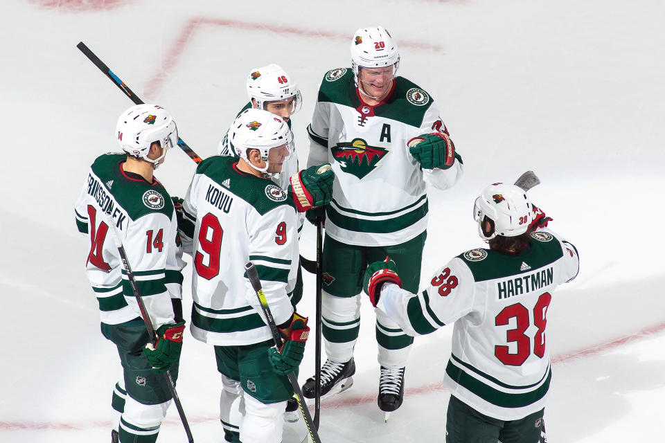 Minnesota Wild's Joel Eriksson Ek (14), Mikko Koivu (9), Jared Spurgeon (46), Ryan Suter (20) and Ryan Hartman (38) celebrate Spurgeon's goal against the Vancouver Canucks during the third period of an NHL hockey playoff game Sunday, Aug. 2, 2020, in Edmonton, Alberta. (Codie McLachlan/The Canadian Press via AP)