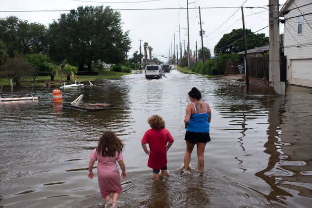 Zailey Segura, Zavery Segura and their mother, Karen Smith, wade through flood waters while walking to the children's father's house after Hurricane Nicholas landed in Galveston, Texas, in September.  (Photo: The Washington Post via Getty Images)