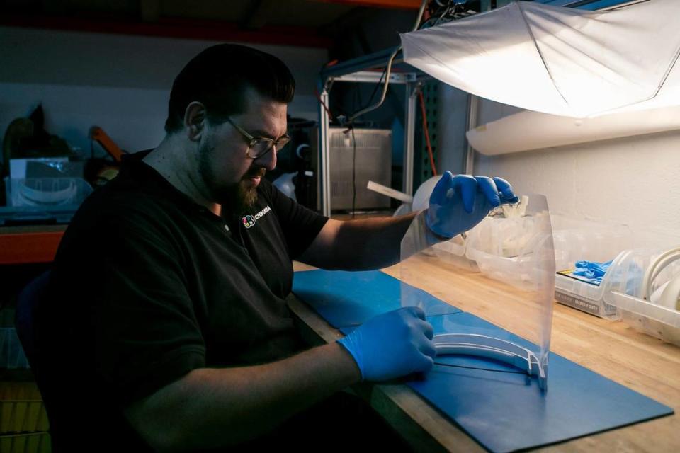 Alexander Hussain, 37, the co-founder of 3D Chimera, puts together a face shield using components he 3D-printed at his office in Miami on March 1, 2020. Hussain plans to sell the face shield to local hospitals to keep workers safe from the coronavirus.