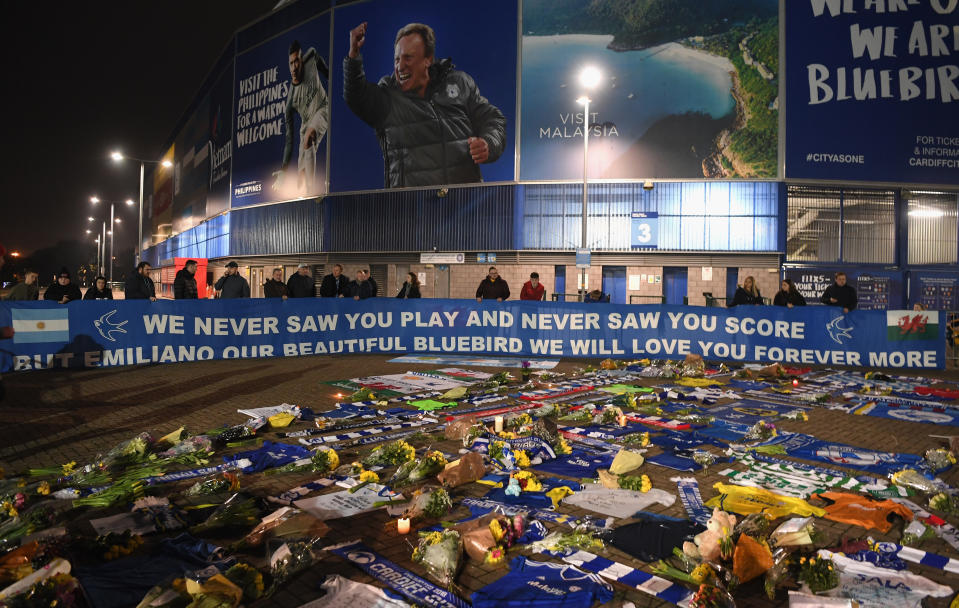 Cardiff City fans unveil a flag in front of tributes for their £15 Million forward Emiliano Sala