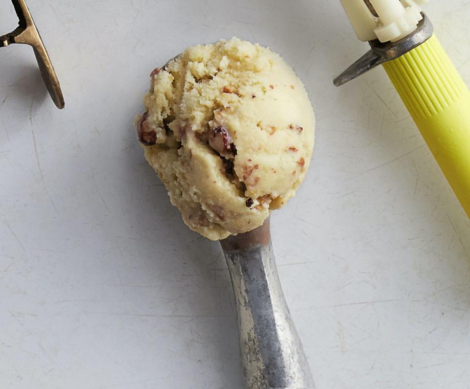 a scoop of brown butter maple nut ice cream in an ice cream scooper