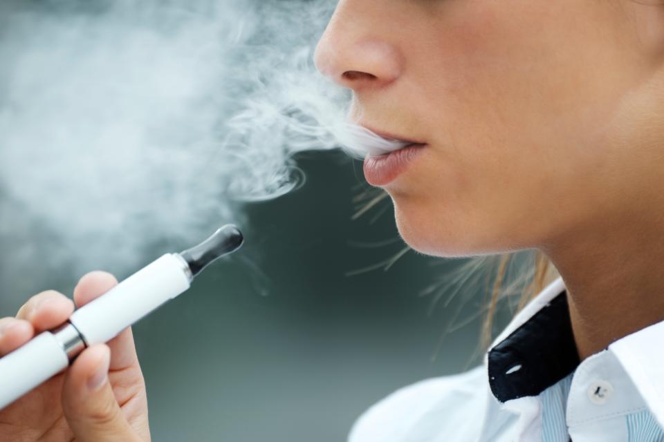 A person exhales e-cigarette "vape."