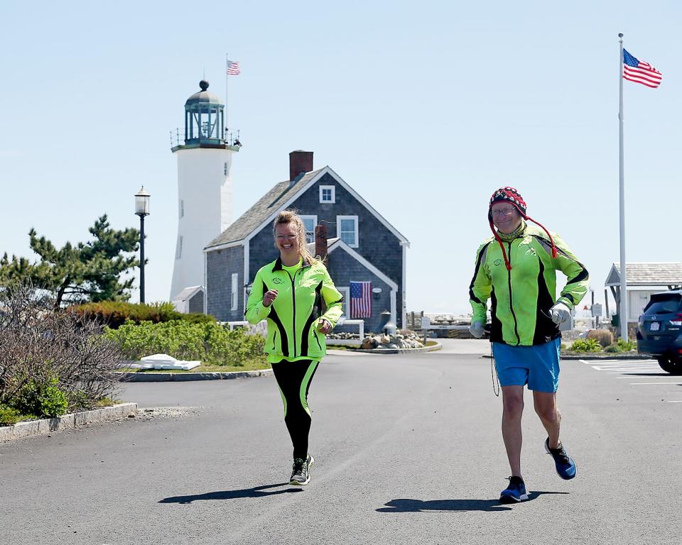 Karen Pajer and Scott Schaeffer-Duffy start their run from the parking lot of Scituate Lighthouse in late April.