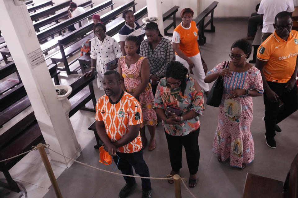 Catholic faithful pray at the Chapelle de l'Externat Saint Paul Church in Abidjan, Ivory Coast, Wednesday, Feb. 7, 2024. Ivory Coast's seemingly miraculous progression to the Africa Cup of Nations semifinals has convinced locals that God is on their side. The host nation has survived several close shaves with elimination thanks to fortune with results in other games and scarcely believable comebacks. (AP Photo/Sunday Alamba)