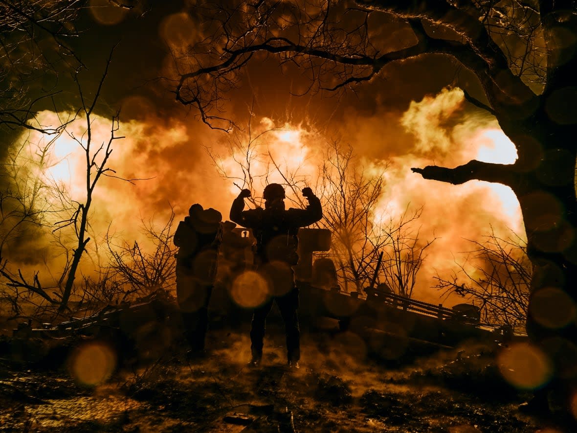 Ukrainian soldiers fire artillery at Russian positions near Bakhmut, Donetsk region, in November. Authorities say the city has been home to the most intense fighting on the front line, in scenes reminiscent of the First World War. (Libkos/The Associated Press - image credit)