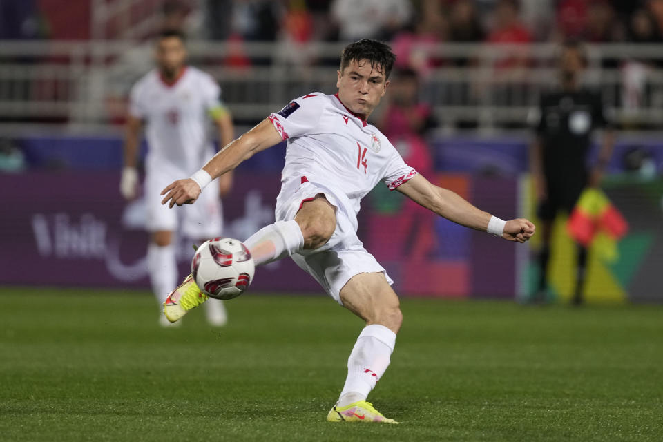 Tajikistan's Shukurov Alisher shoots the ball during the Asian Cup Group A soccer match between China and Tajikistan at Abdullah Bin Khalifa Stadium in Doha, Qatar, Saturday, Jan. 13, 2024. (AP Photo/Thanassis Stavrakis)