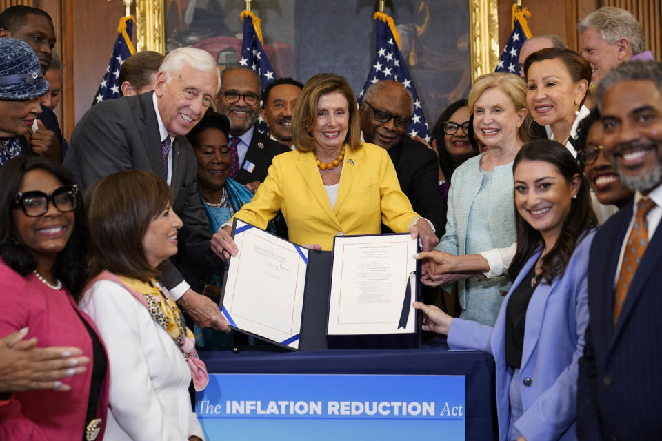 FILE - House Speaker Nancy Pelosi of Calif., and the House Democrats with her, celebrate after Pelosi signed the Inflation Reduction Act of 2022 during a bill enrollment ceremony on Capitol Hill in Washington, Aug. 12, 2022. (AP Photo/Susan Walsh, File)