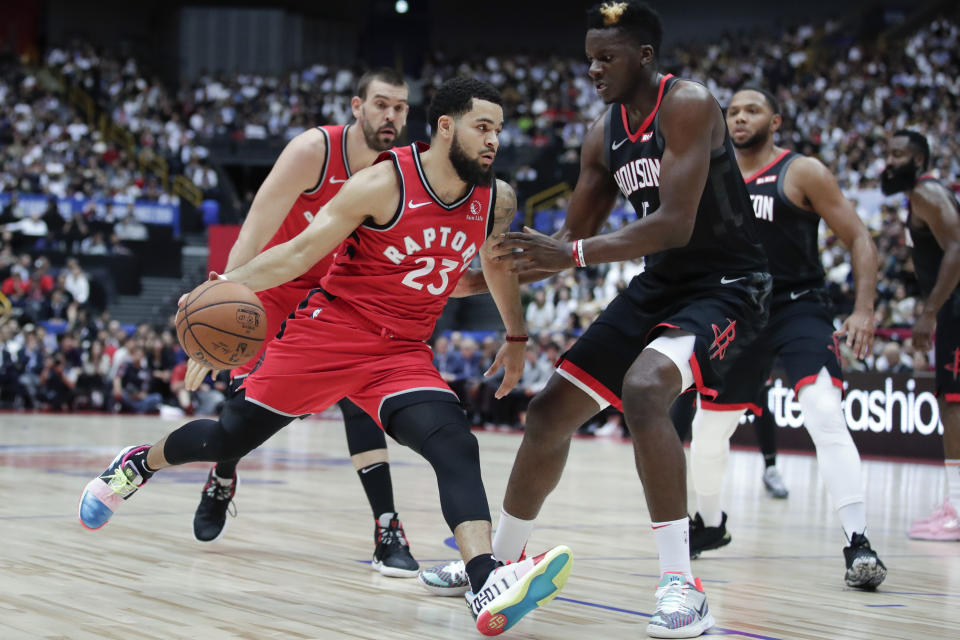 Toronto Raptors' Fred VanVleet, left, drives past Houston Rockets' Clint Capela during the first half of an NBA preseason basketball game Thursday, Oct. 10, 2019, in Saitama, near Tokyo. (AP Photo/Jae C. Hong)