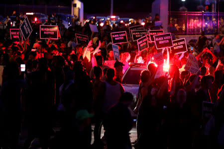 Protesters are blocked by police as they attempt to walk down a ramp to Interstate 64 after the not guilty verdict in the murder trial of Jason Stockley, a former St. Louis police officer, charged with the 2011 shooting of Anthony Lamar Smith, who was black, in St. Louis, Missouri, U.S., September 15, 2017. REUTERS/Whitney Curtis