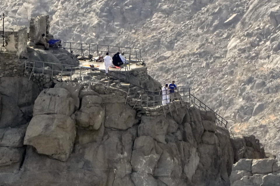 Muslim pilgrims pray at Hira's Cave, where Muhammad, Muslim's prophet, is believed to have received the first verses of the Quran, the Muslim holy book, in the mountains on the edge of Mecca, Saudi Arabia, Friday, June 30, 2023. (AP Photo/Amr Nabil)