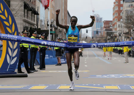 Edna Kiplagat of Kenya crosses the finish line to win the women’s division of the 121st Boston Marathon in Boston, Massachusetts, U.S., April 17, 2017. REUTERS/Brian Snyder