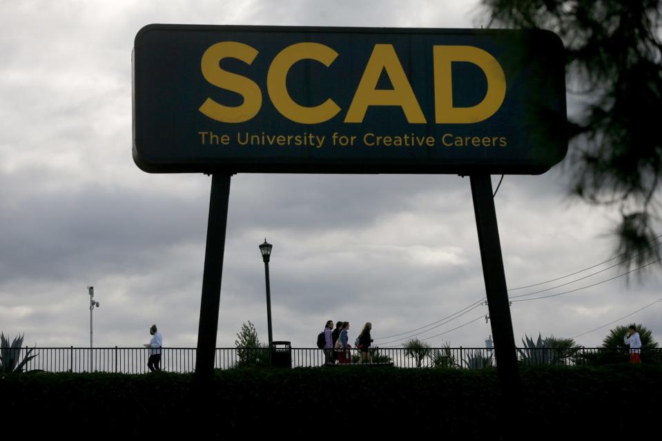 Savannah College of Art and Design students cross the former railroad trail connecting Turner House to the Hive on Boundary Street.