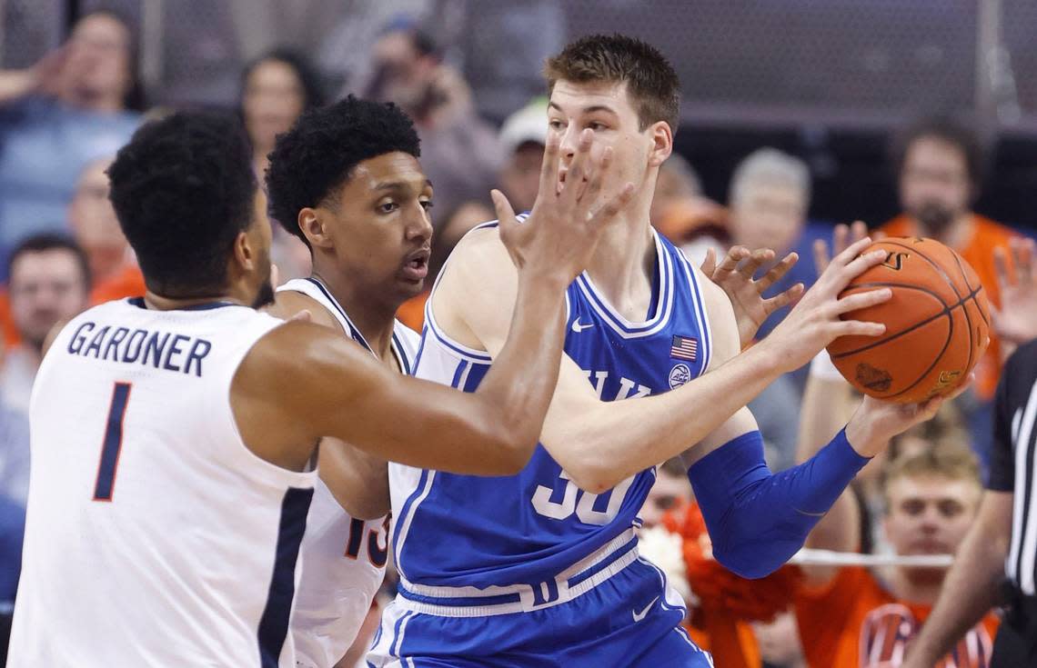 Duke’s Kyle Filipowski (30) works around the defense of Virginia’s Jayden Gardner (1) and Ryan Dunn (13) defend during the first half of Duke’s game against Virginia in the finals of the ACC Men’s Basketball Tournament in Greensboro, N.C., Saturday, March 11, 2023.