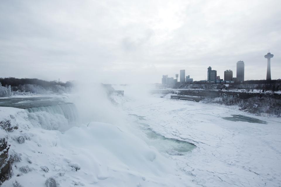 A snow-covered landscape is seen over the frozen Niagara Falls in Niagara Falls, New York