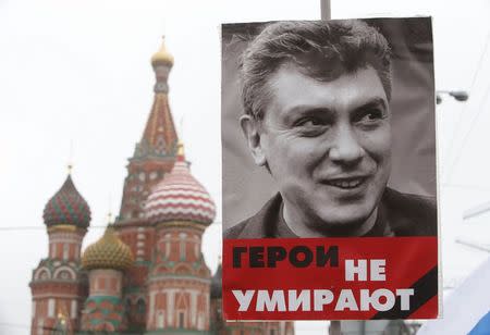 A poster of Kremlin critic Boris Nemtsov, who was shot dead on Friday night, is seen during a march to commemorate him near St. Basil's Cathedral in central Moscow March 1, 2015. The poster reads, "Heroes don't die". REUTERS/Sergei Karpukhin