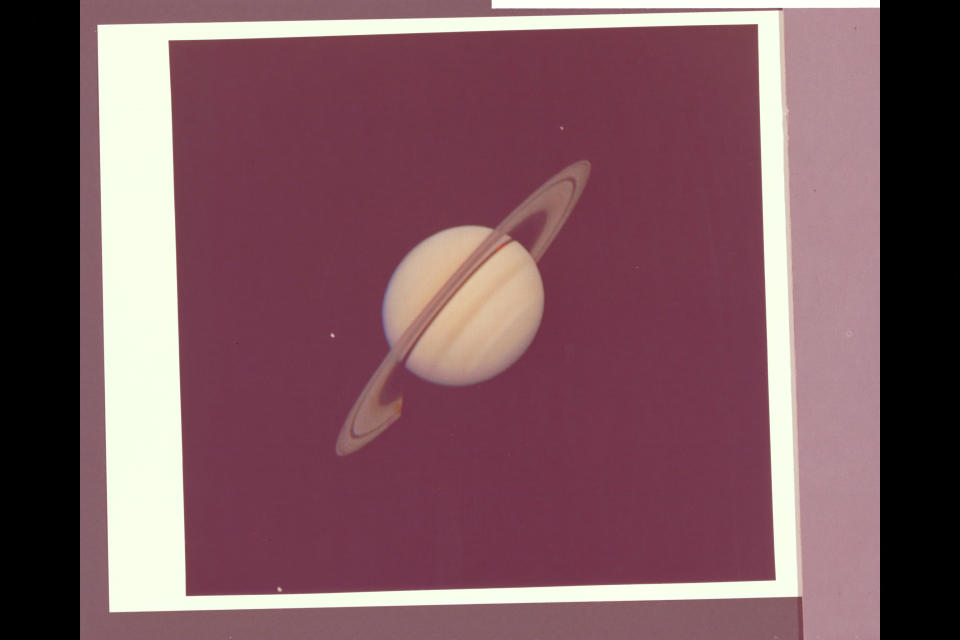 Voyager image shows Saturn and its satellites.