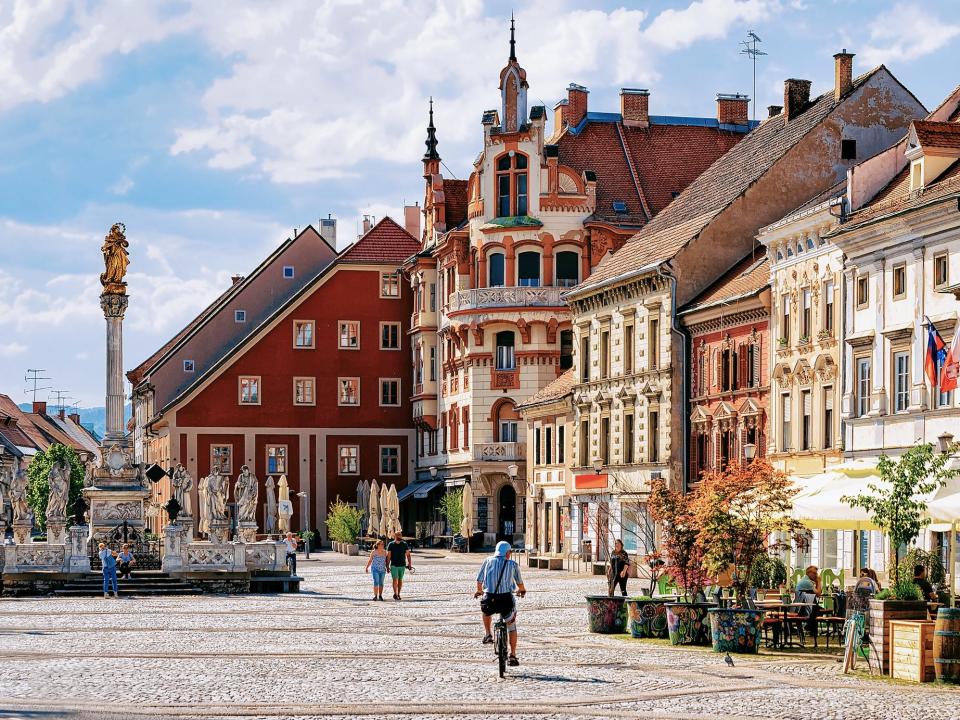 people milling about a town square in a town in Slovenia