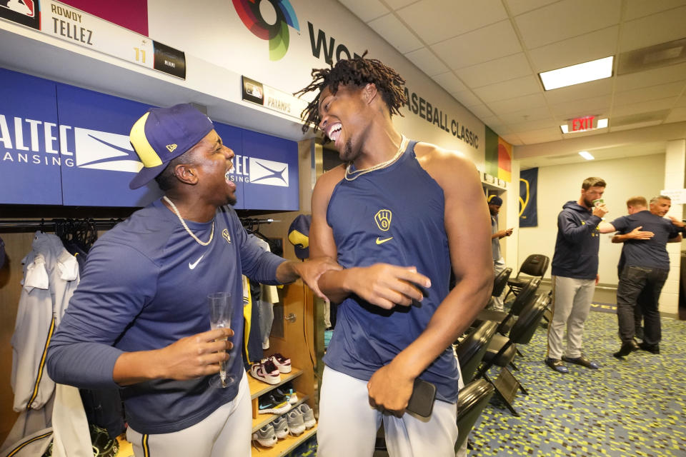 Milwaukee Brewers players Thyago Vieira, left, and Abner Uribe celebrate in the clubhouse after the Brewers beat the Miami Marlins 16-1 in a baseball game and clinching a postseason berth, Friday, Sept. 22, 2023, in Miami. (AP Photo/Wilfredo Lee)