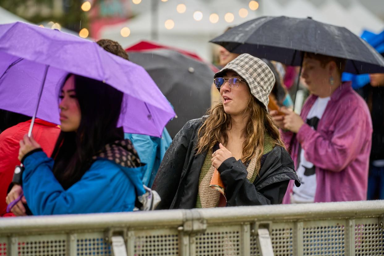 Carly Golisch dances and enjoys the music in the rain as Pariah Pete performs on the Ronstadt stage during day one of the ZONA Music Festival at Margaret T. Hance Park on Saturday, Dec. 3, 2022.