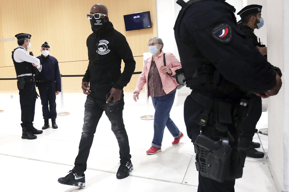 An activist from a group called the Anti-Negrophobia Brigade, Franco Lollia, wears a face mask reading « Anti-Negrophobia Brigade » as he arrives at the Paris courthouse, in Paris, May 10, 2021. Lollia stands accused of covering in graffiti a statue that honours Jean-Baptiste Colbert, a 17th century royal minister who wrote rules governing slaves in France's overseas colonies. (AP Photo/Thibault Camus)