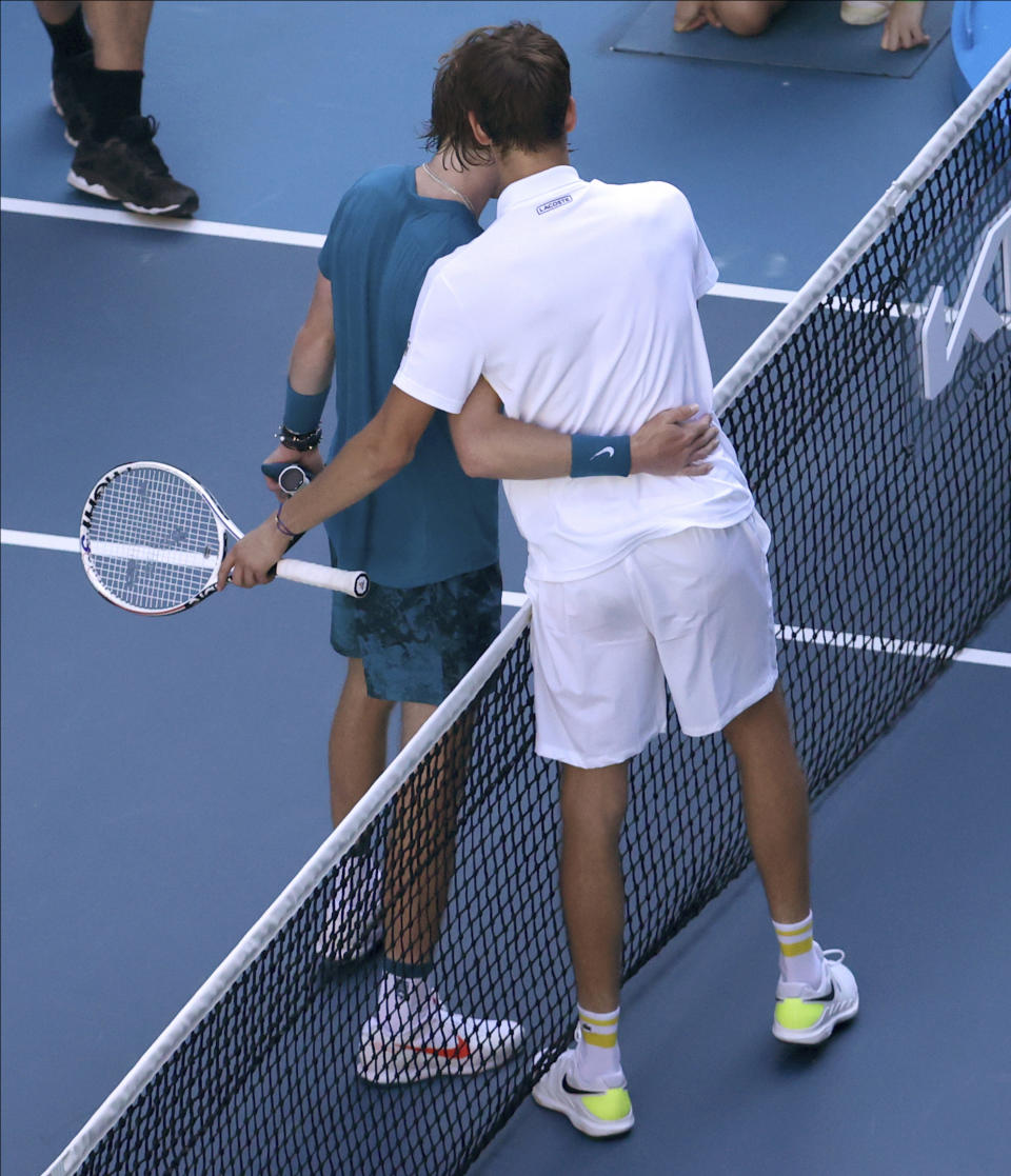 Russia's Daniil Medvedev, right, is congratulated by compatriot Andrey Rublev after winning their quarterfinal match at the Australian Open tennis championship in Melbourne, Australia, Wednesday, Feb. 17, 2021.(AP Photo/Hamish Blair)