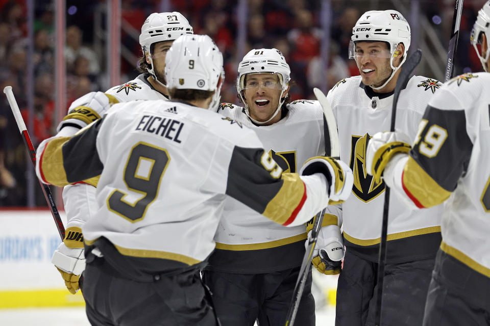 Vegas Golden Knights' Jonathan Marchessault, center, celebrates his goal with teammates Shea Theodore, back left, Jack Eichel (9), Brayden McNabb, second right, and Ivan Barbashev (49) during the first period of an NHL hockey game against the Carolina Hurricanes in Raleigh, N.C., Saturday, March 11, 2023. (AP Photo/Karl B DeBlaker)