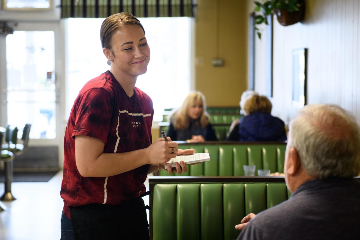 Amber Chavis takes a customer's order at Continental Cafe in Eutaw Shopping Center on Thursday, Jan. 20, 2022.