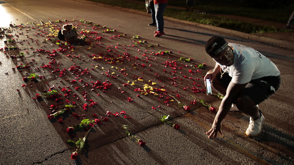 Donzell Clark photographs the rebuilt memorial for Michael Brown on Canfield Drive in Ferguson, Mo., on Thursday, July 30, 2020, at the spot where the teen was shot and killed by a Ferguson police officer in 2014. St. Louis County’s prosecutor announced Thursday that he will not charge the former police officer who fatally shot Michael Brown in Ferguson. (Robert Cohen /St. Louis Post-Dispatch via AP)
