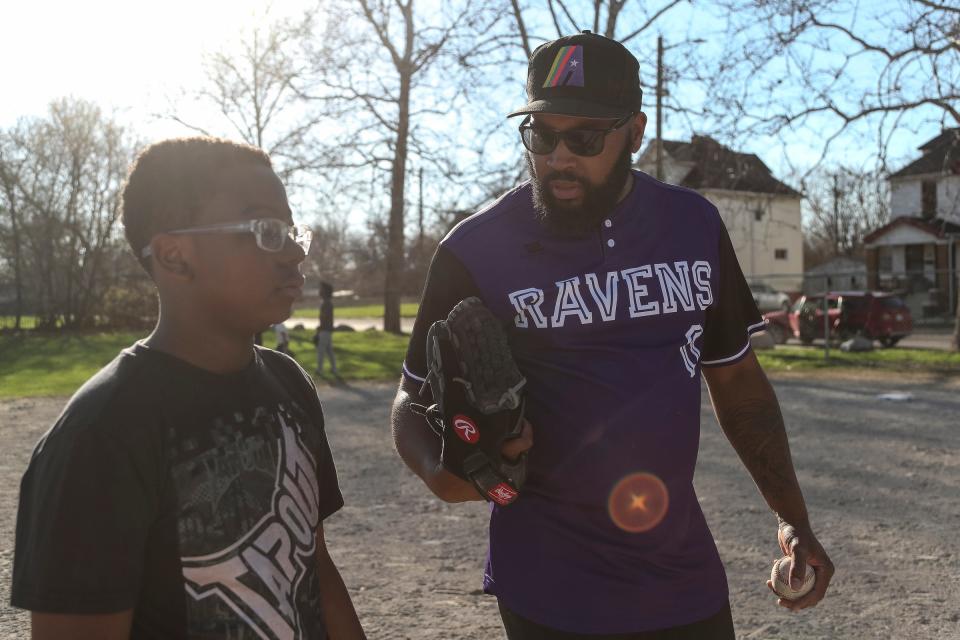 Vincent McMullen, also called Coach Mac, offers words of encouragement to Davion Bell, 13, of the Motor City Ravens youth baseball team during practice at Calcara Park in Detroit on Wednesday, April 13, 2023.
