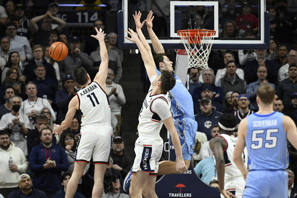 Creighton center Ryan Kalkbrenner misses a dunk attempt under pressure from UConn forward Alex Karaban, left, and UConn center Donovan Clingan, center, in the first half of an NCAA college basketball game, Wednesday, Jan. 17, 2024, in Stores, Conn. (AP Photo/Jessica Hill)