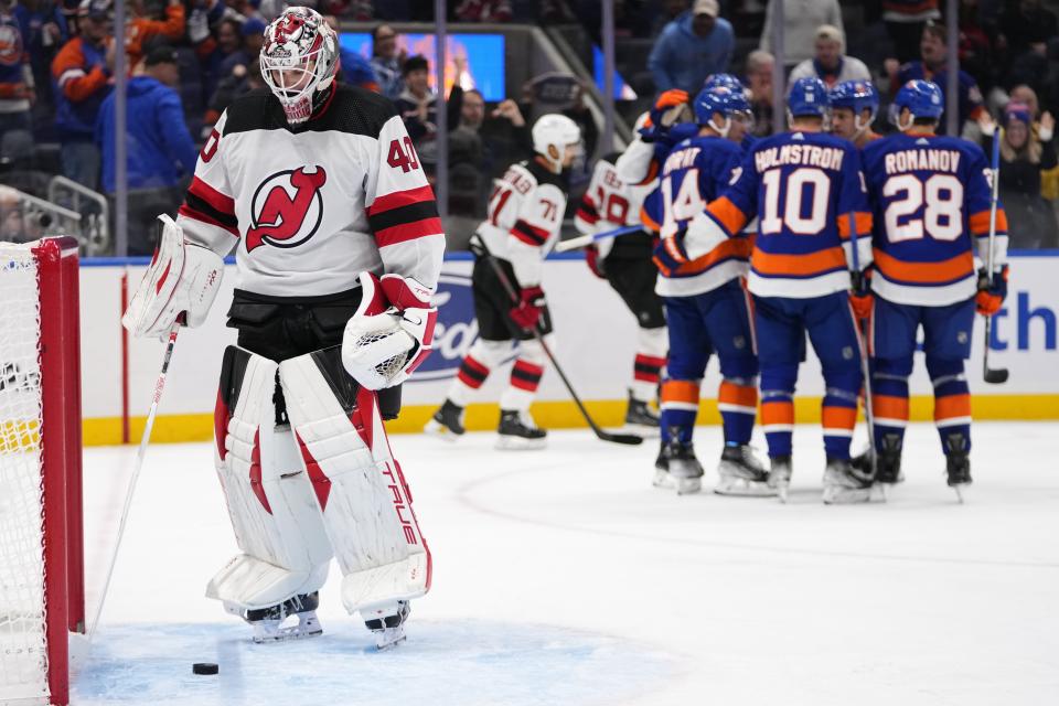 New Jersey Devils goaltender Akira Schmid (40) reacts as the New York Islanders celebrate a goal by Bo Horvat during the second period of an NHL hockey game Friday, Oct. 20, 2023, in Elmont, N.Y. (AP Photo/Frank Franklin II)