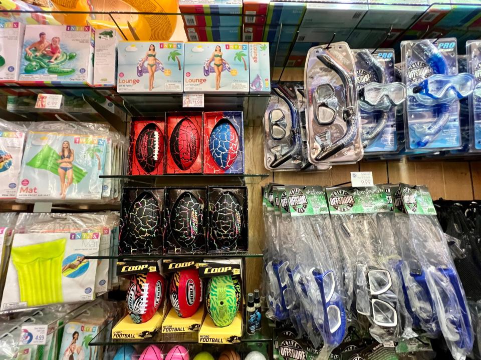 Display of plastic footballs, snorkeling gear, and floatation devices in gift shop