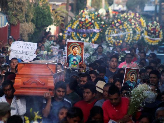 The funeral procession of Samir Flores Soberanes, a Mexican activist gunned down outside his home on 20 February 2019 (REUTERS)