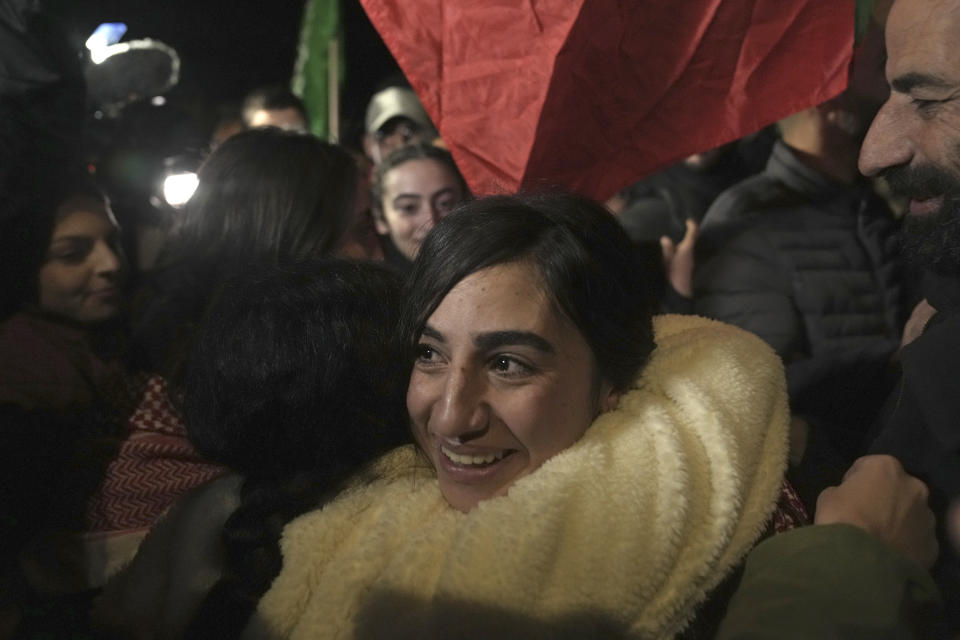 Palestinian prisoner Ruba Assi is greeted after she was released, in the West Bank town of Ramallah, early Wednesday Nov. 29, 2023. Hamas and Israel released more hostages and prisoners under terms of a fragile cease-fire that held for a fifth day Tuesday. (AP Photo/Nasser Nasser)