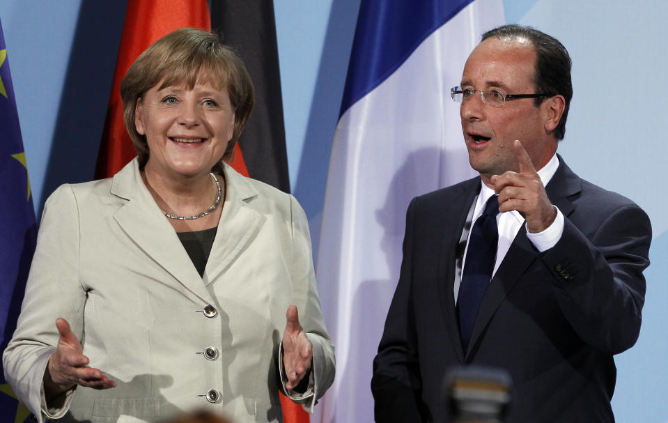 German Chancellor Angela Merkel, left, and the President of France, Francois Hollande, right, gesture after a press conference as part of a meeting at the chancellery in Berlin, Germany, Tuesday, May 15, 2012. (AP Photo/Michael Sohn)