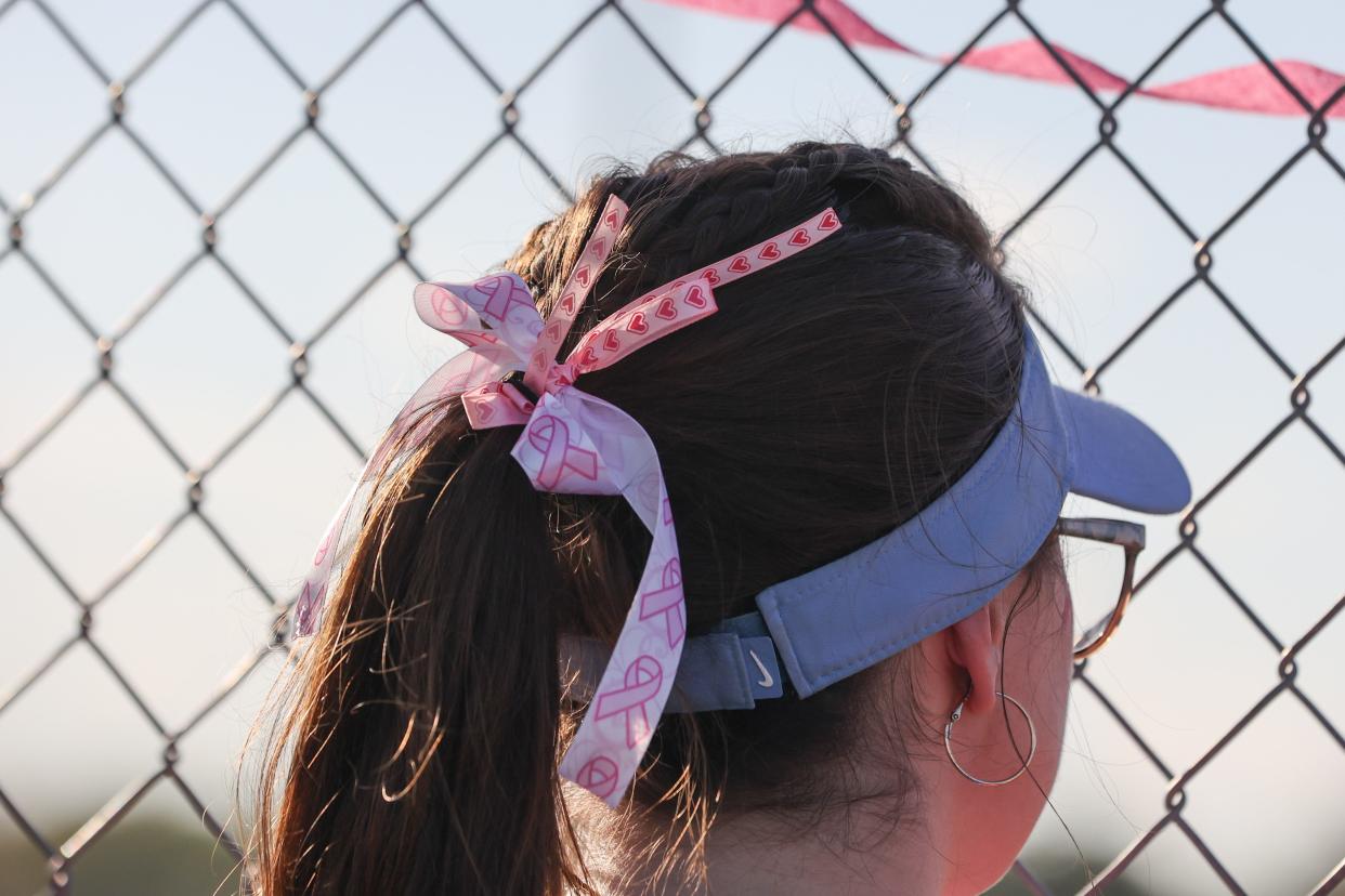 John Jay softball players, including Caitlin Kroohs, sport pink uniforms, hair ribbons, temporary tattoos and stickers during John Jay's May 1, 2024 "Pink Out" game in support of Miles for Hope Breast Cancer Foundation.