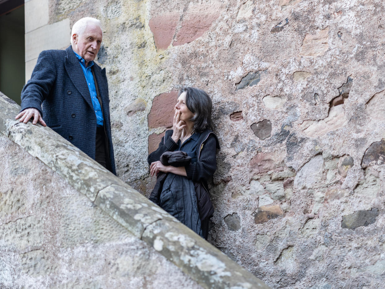 David and Liza Dimbleby standing near each other on steps