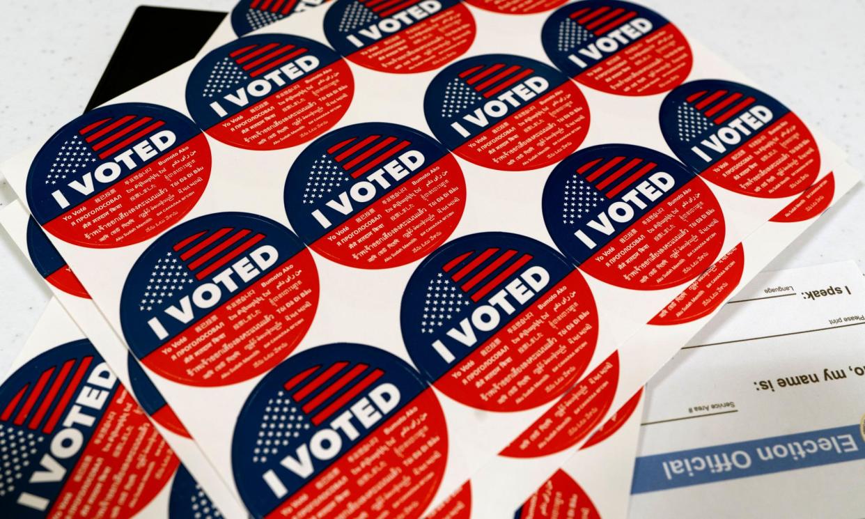 <span>I Voted stickers are offered to voters after casting their ballot on Super Tuesday, at the Ranchito elementary school polling station in Los Angeles.</span><span>Photograph: Richard Vogel/AP</span>