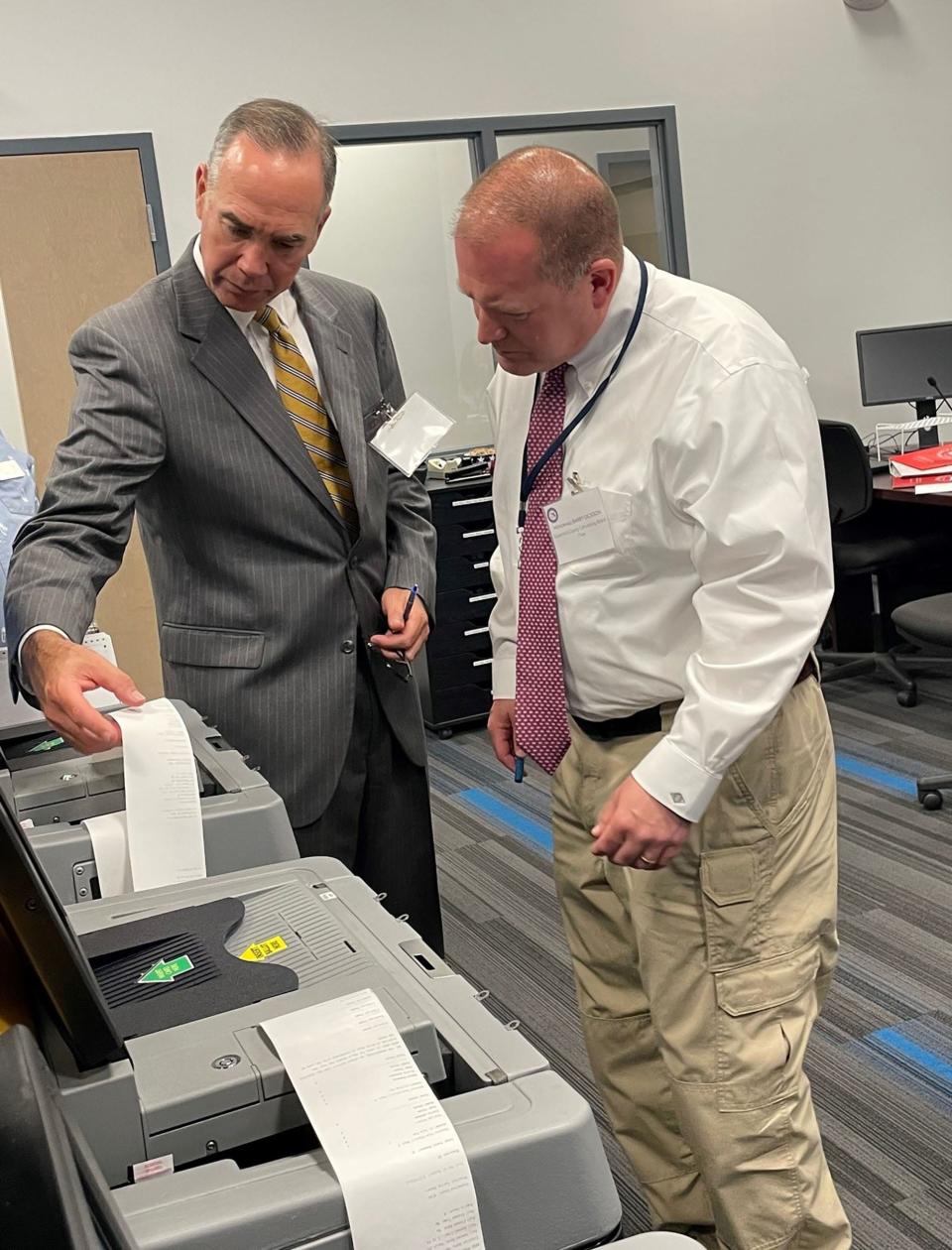 Escambia County Supervisor of Elections David Stafford, left, reviews the Century Logic & Accuracy Testing process during a March 2023 Special Election. Stafford's position is one of the many offices that will be on the ballot in 2024.