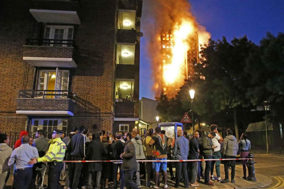 Residents wait at a police cordon after the Grenfell Tower burst into flames (Nigel Howard)