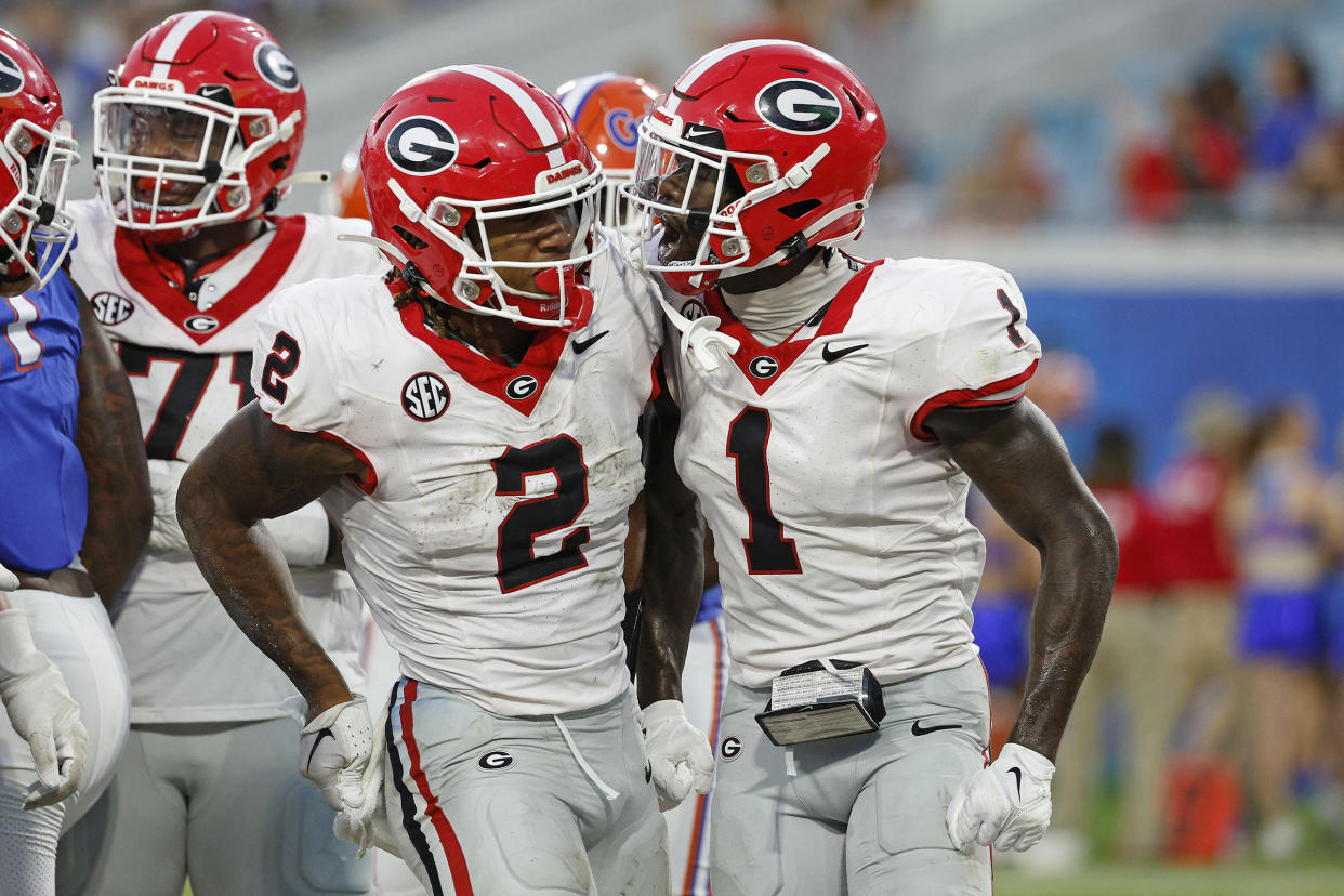 Georgia running back Kendall Milton (2) is congratulated by wide receiver Marcus Rosemy-Jacksaint (1) after a touchdown on Saturday. (Jeff Swinger-USA TODAY Sports)