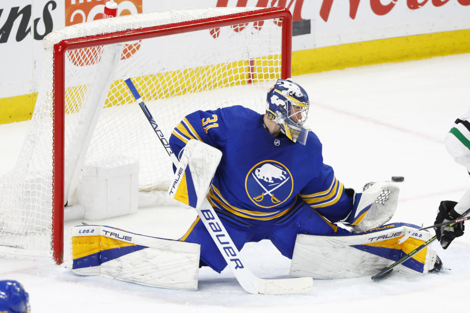 Buffalo Sabres goaltender Eric Comrie (31) makes a pad-save during the third period of an NHL hockey game against the Dallas Stars, Thursday, March 9, 2023, in Buffalo, N.Y. (AP Photo/Jeffrey T. Barnes)