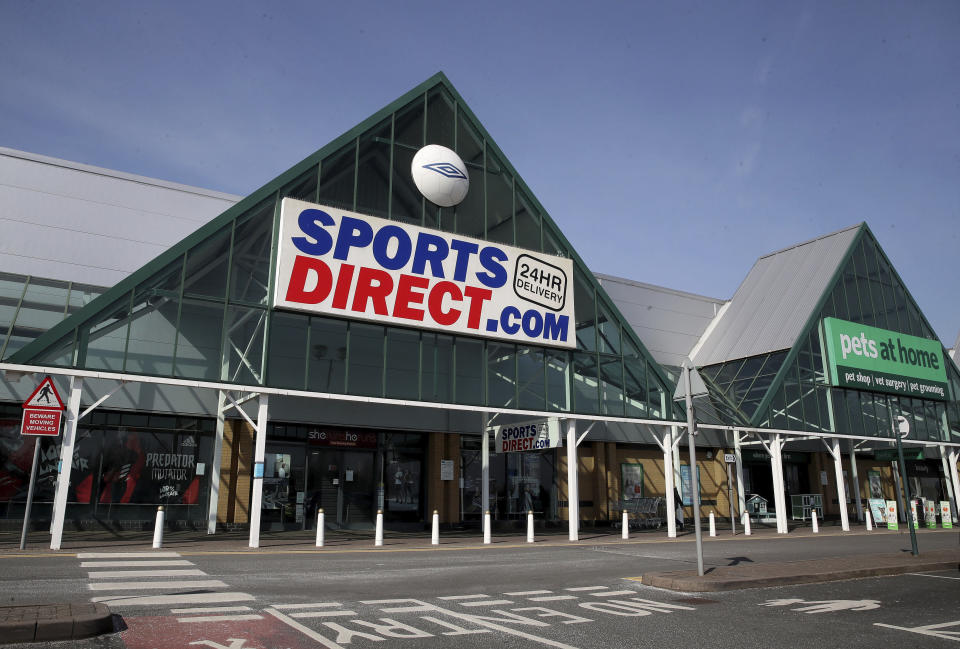 A view of a closed Sports Direct store next to an open Pets at Home store, the day after Prime Minister Boris Johnson put the UK in lockdown to help curb the spread of the coronavirus. Sports Direct has said it will close its stores in a major U-turn after initially calling for its workers to continue selling essential sports and fitness equipment in the face of the coronavirus outbreak, in Telford, England, Tuesday March 24, 2020.  For some people the COVID-19 coronavirus causes mild or moderate symptoms, but for others it causes severe illness. (Nick Potts / PA via AP)